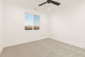 Carpeted empty room with baseboards and recessed lighting
