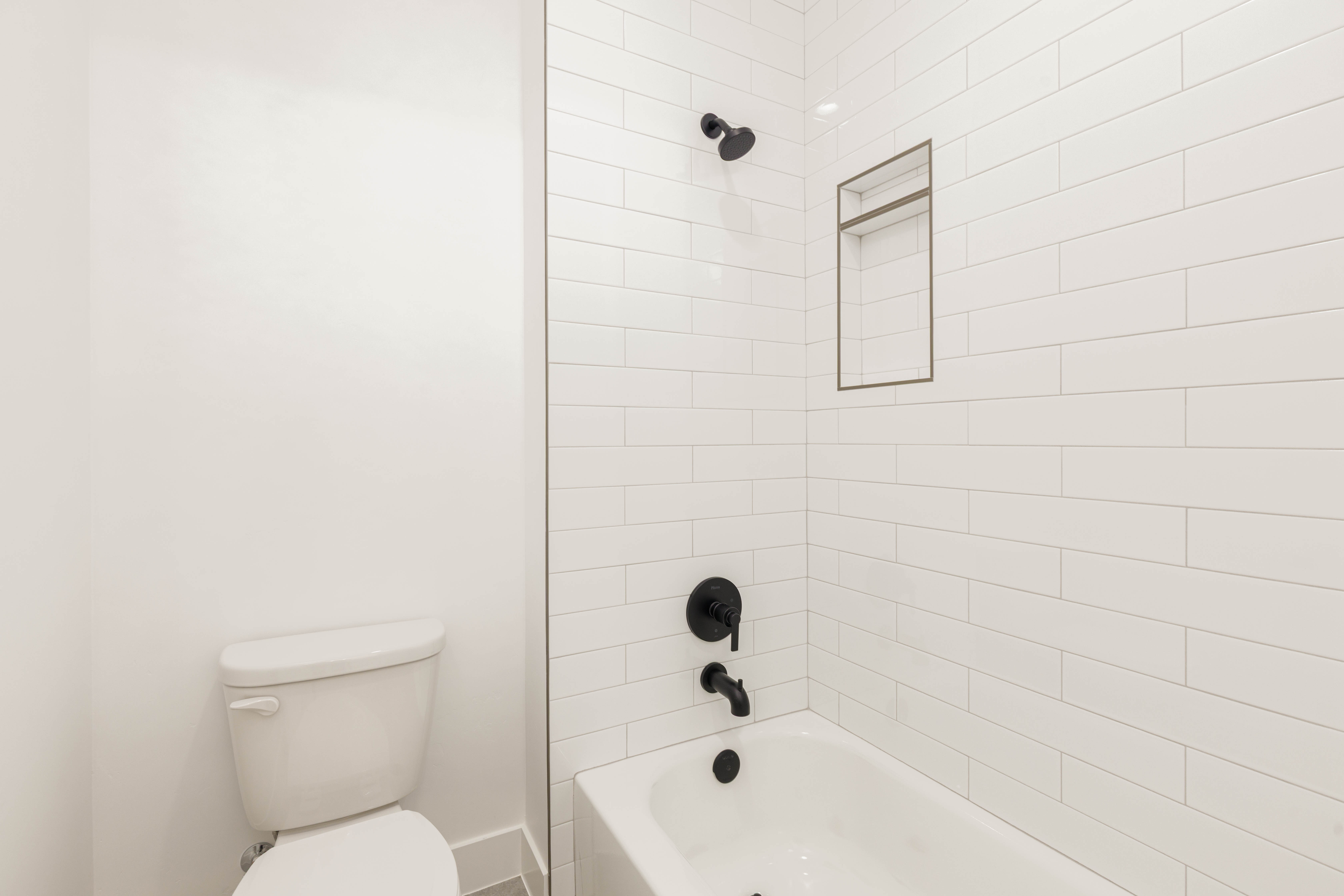 Bathroom featuring bathing tub / shower combination and toilet