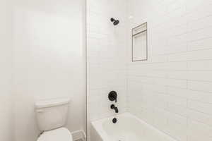 Bathroom featuring bathing tub / shower combination and toilet