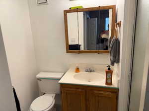 Half bath with vanity and toilet