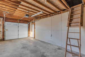 Garage with automatic door and storage access up above..
