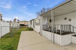 View of patio featuring a storage shed