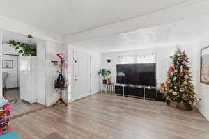Living room with light wood finished floors and a textured ceiling