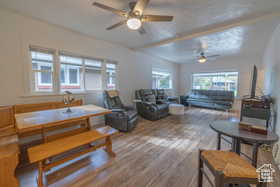 Living area featuring wood finished floors and a ceiling fan
