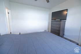 Bedroom featuring ceiling fan and lofted ceiling