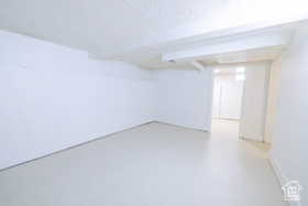 Finished below grade area featuring a textured ceiling