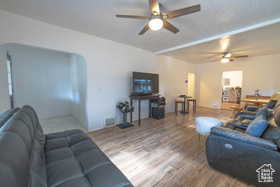 Living room with wood finished floors and a ceiling fan