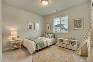 (VIRTUALLY STAGED)  featuring light carpet and a textured ceiling