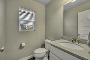 Bathroom with vanity and baseboards