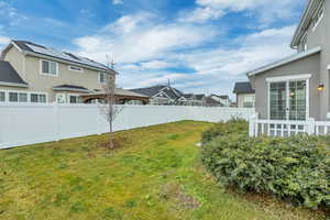 Fenced backyard with a residential view