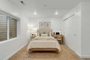 (VIRTUALLY STAGED) Carpeted bedroom with baseboards and a closet