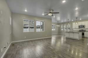Unfurnished living room with ceiling fan, recessed lighting, and light wood-type flooring