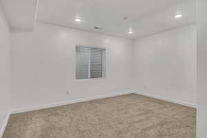 Unfurnished room featuring light carpet and recessed lighting