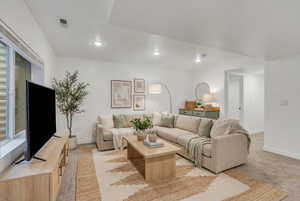 (VIRTUALLY STAGED) Living area featuring light carpet and recessed lighting