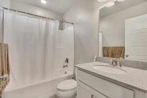 Full bath featuring vanity and shower / bath combo with shower curtain