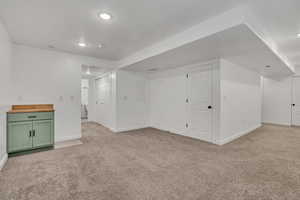 Bonus room with light carpet and recessed lighting