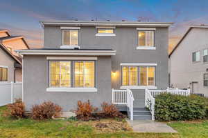 Traditional-style house with stucco siding and a deck