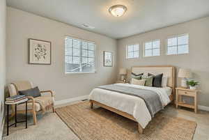 (VIRTUALLY STAGED) Bedroom featuring carpet floors and a textured ceiling