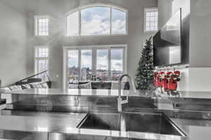Kitchen featuring plenty of natural light, dark stone counters, and open floor plan