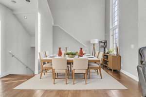 Dining room with wood finished floors and a high ceiling