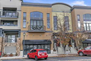 View of building exterior with uncovered parking