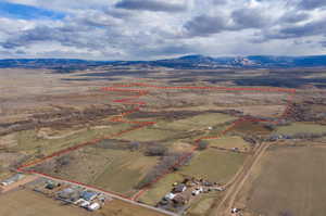 Overview of rural landscape featuring property parcel outlined and a mountainous background