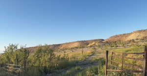 View of mountain backdrop featuring rural landscape