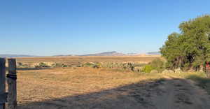 View of mountain background featuring rural landscape