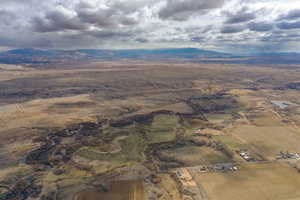 Aerial overview of property's location featuring a mountainous background and rural landscape