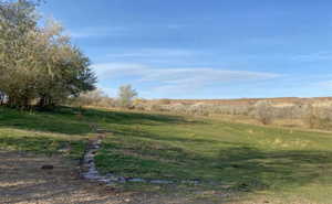 View of green lawn featuring a view of rural / pastoral area