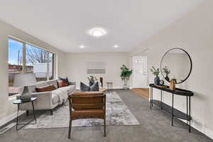 Living area with baseboards and carpet flooring
