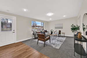 Living area featuring dark wood-style floors and recessed lighting