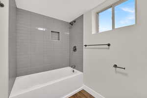 Full bath featuring shower / bathtub combination and wood finished floors