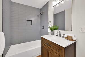 Bathroom featuring vanity and shower / washtub combination