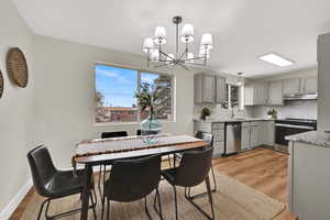 Dining area featuring light wood-style floors and a chandelier