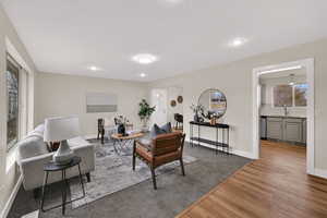 Living room with wood finished floors and recessed lighting