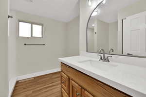 Full bathroom with vanity and light wood finished floors