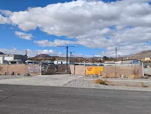 View of yard with a mountain view and a gate