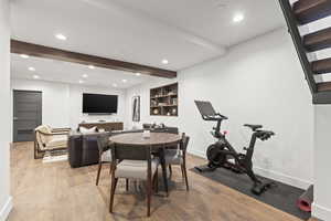 Dining area featuring recessed lighting, beamed ceiling, and light wood-style floors