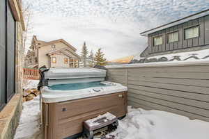 View of patio with a hot tub