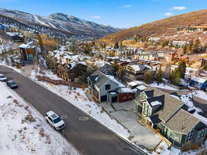 Snowy aerial view featuring a residential view and a mountain view