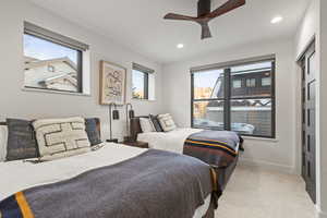 Bedroom with multiple windows, light colored carpet, ceiling fan, a closet, and recessed lighting