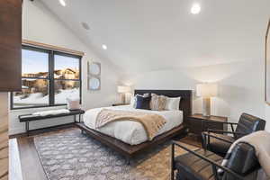 Bedroom with recessed lighting, lofted ceiling, and wood finished floors