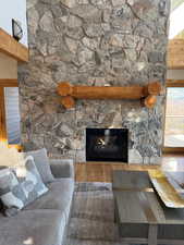 Detailed view of a stone fireplace and wood finished floors
