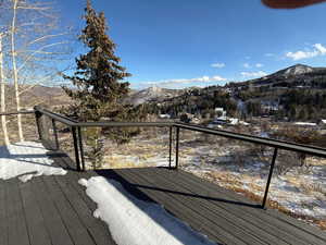 Snow covered deck featuring a mountain view