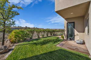 View of green lawn with a patio