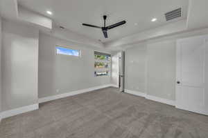 Unfurnished bedroom with light colored carpet, ceiling fan, and recessed lighting