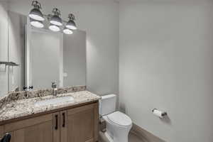 Bathroom featuring vanity and toilet