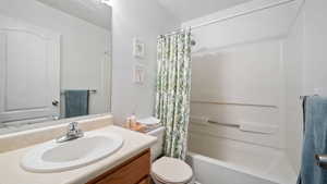 Full bathroom featuring vanity and shower / bath combo with shower curtain
