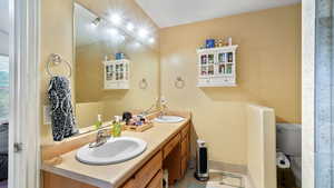 Full bath with double vanity and toilet